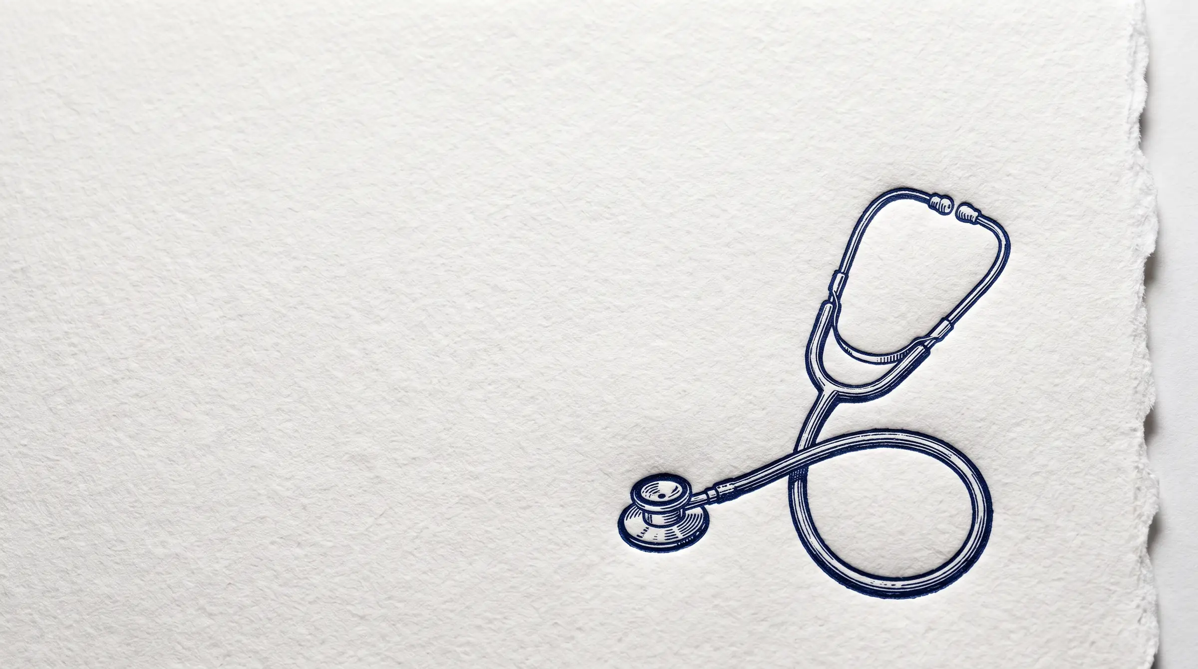 A letterpress print: a stethoscope pressed in deep navy ink into thick white cotton paper with a deckled edge, lit from the side so the impression casts a soft shadow.